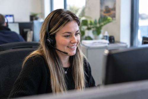 Sales Support happy smiling lady on phone in office